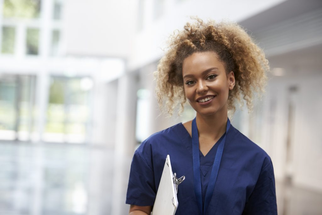travel nursing vs. staff nursing - image of nurse in hospital lobby