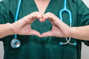 Picture of nurse making heart with her hands