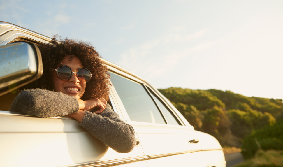 Picture of traveling nurse looking out the window of her car